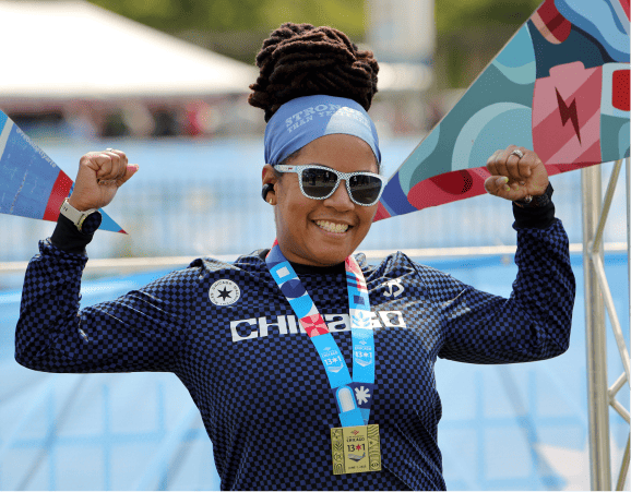 A runner at the finish line of the Chicago 13.1 with a medal around their neck