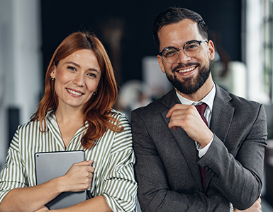 A man and a women smile at the camera