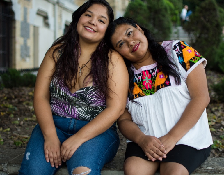 Mother and daughter sitting outside.