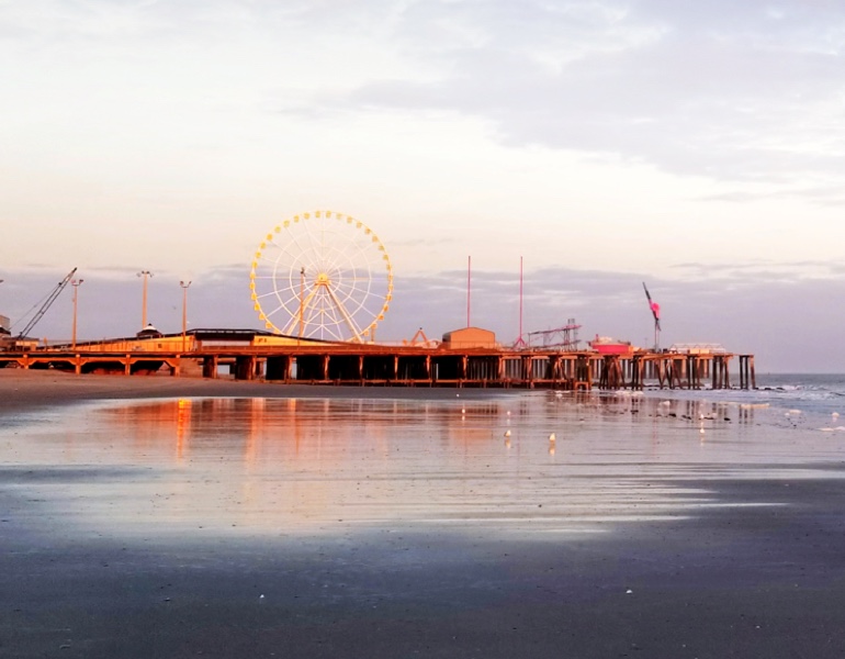 New Jersey boardwalk and ferris wheel at sunset