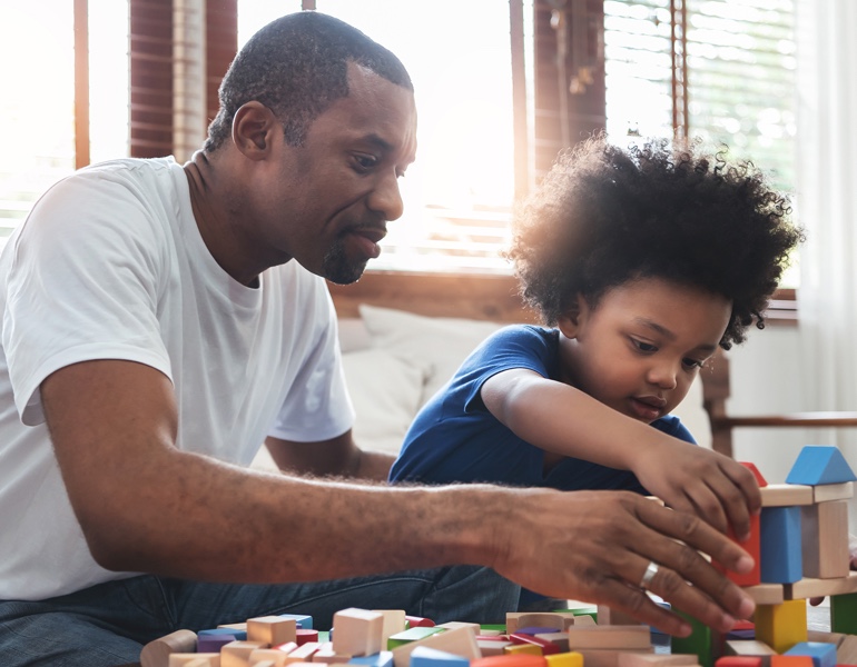 Father and son playing with toy