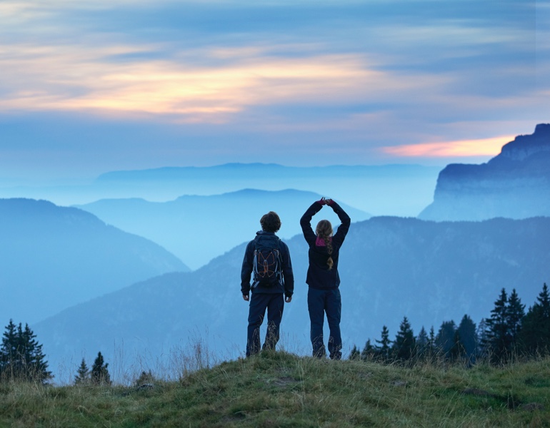 two people on a background of mountains