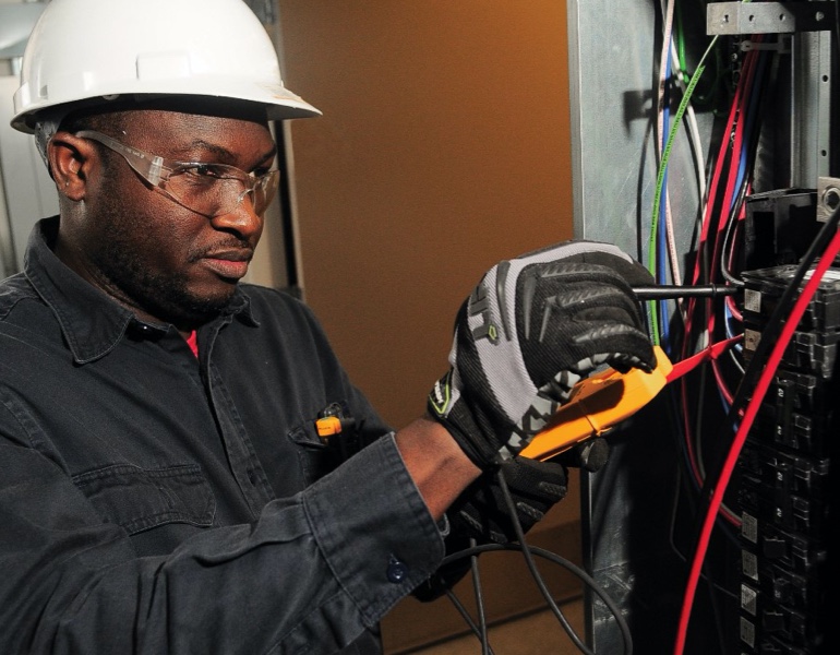 Employee working with technical and electrical components.