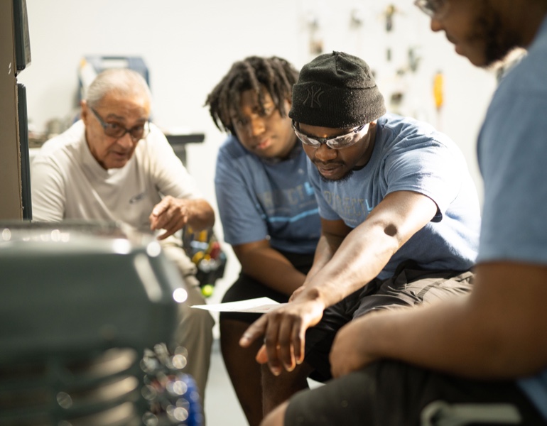 Four people working on HVAC