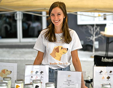 Rachel Heim, founder and small business owner of Vanilla Joe & Co, displaying her candles
