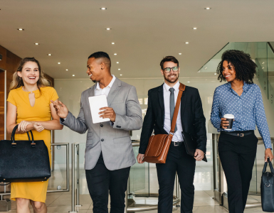 A team of smiling Bank of America employees starting their workday